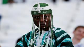 A Nigeria fan watches their victory over Iceland